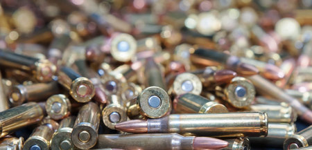 A close up of a pile of .223 and 45 caliber as well as 9mm bullets