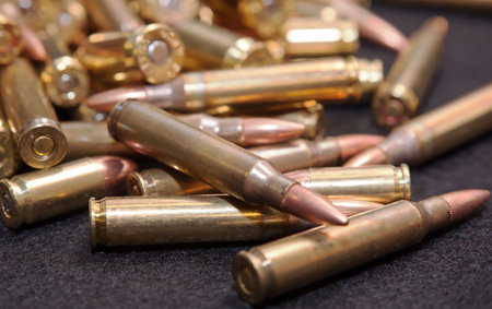 A close up of a pile of .223 and 45 caliber as well as 9mm bullets