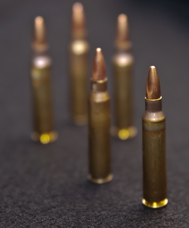 Five .223 rounds on a black backgroundの写真素材