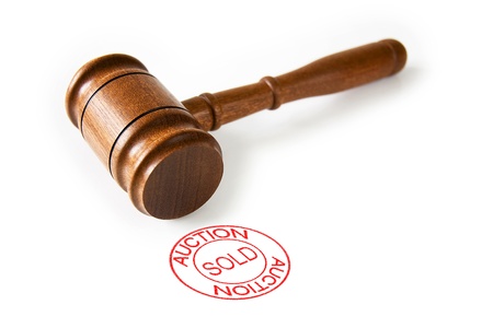A brown wooden auctioneer's hammer with a red circle sold stampの写真素材