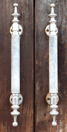 detail steel and ceramic handle of wood doorの写真素材