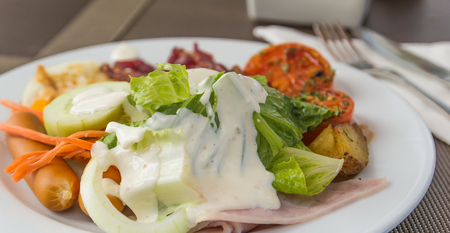 closeup of breakfast with egg, bacon, tomato and saladの写真素材