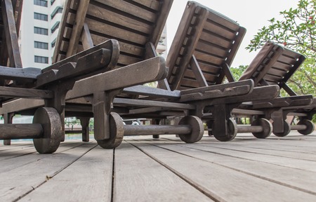 backside of wooden chair inside swimming poolの写真素材