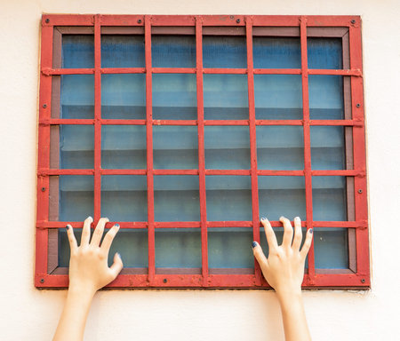 hands of young female catching red grille steel of restroom