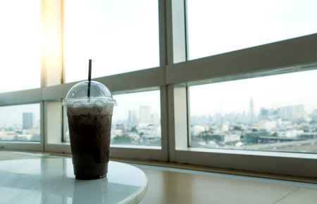 ice coffee cup on white table in modern coffee shop