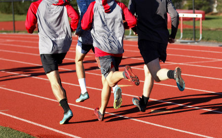 A group of boys training for cross country on a track