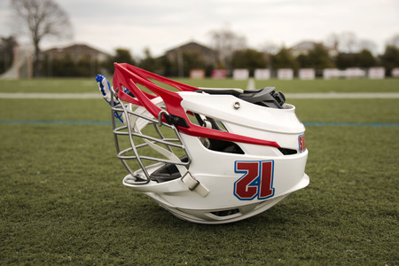 A lacrosse helmet is upside down on a green turf fieldの写真素材