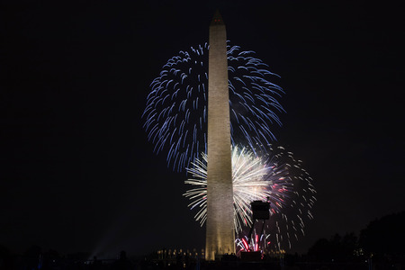 Washington DC, USA - 4 July 2017: Red, white and blue fireworks light the sky behind The Washington Monument, on the mall in DCのeditorial素材