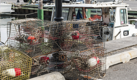 Crab traps are sitting on the ground at the docks ready to be filled with bait and put back into the water.の写真素材