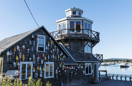 Tremont, Maine, USA - 30 July 2018: lobster buoys are hanging from a house dedcated to Clarence Harding house in Bass Harbor Maine.のeditorial素材
