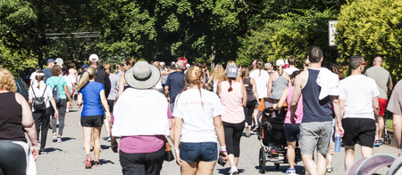 Bay Shore, NY, USA - 16 June 2018: Walkers line the road at the back of the Run For PWS fundraising 5K on local roads in Bay Shore.のeditorial素材