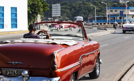 Havana, Cuba - 25 July 2018: A classic vintage red 1950s convertible is being driven on roads in Havana Cuba.のeditorial素材