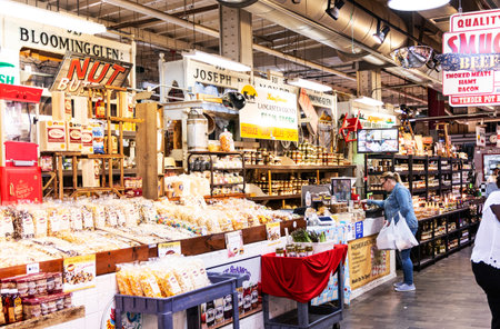 Philadelphia, Pennsylvania, USA - 26 April 2019: The inside of Reading Market with people shopping locally grown goods and popcorn.