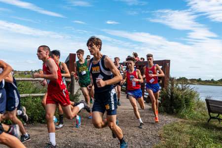 Kings Park, New York, USA - 22 September 2018: High school boys cross country race as they turn...