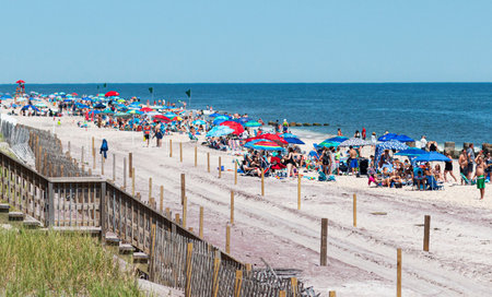 Ocean Beach, New York, USA - 23 June 2019: Fire Island National Sea Shore is crowded on a hot early...