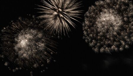 White fireworks display coming apart in the light wind during a perfomance in a park.の写真素材