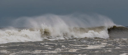 The wind is blowing the top of ocean waves backwards during an October Tropical Storm off of the...