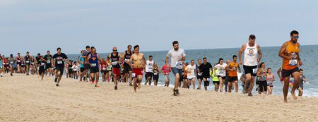 Babylon, New York, USA - 24 June 2019: Hundreds of runners are running a one mile race on the beach as part of the New York State Parks Summer Series of races.のeditorial素材