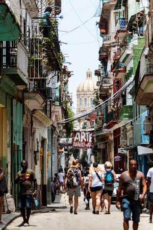 Havana, Cuba - 25 July 2018: Horizontal view of people walking down a city street in Havana Cuba on a summer morning with the Capitol building in the background.のeditorial素材