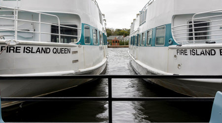 Bay Shore, New York, USA - 6 October 2019: Half of two Fire Island ferry boats docked closed...