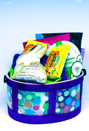 Babylon, New York, USA - 21 April 2019: A childs Easter basket with candy, books and presents and a...