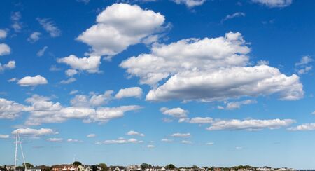 Thick white puffy clouds looking low over the horizon.の写真素材