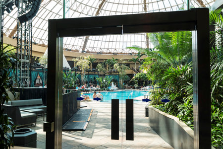 Atlantic City, New Jersey, USA - 20 February 2018: People enjoyin an indoor pool at Harrah's resort with glass dome ceiling.のeditorial素材