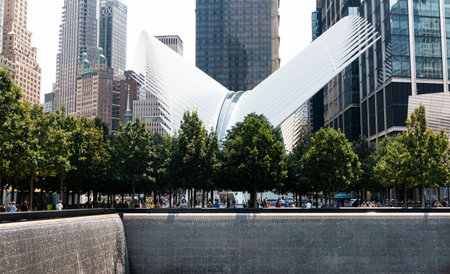New York City, New York, USA - 28 July 2021: Water falling in the reflecting pools with the...