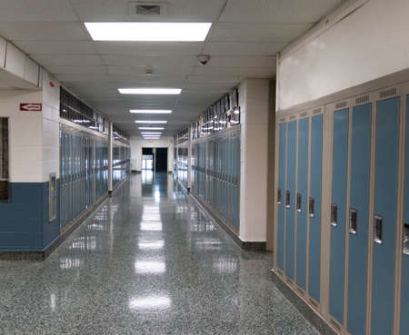 Inside of and American High School looking down a hallway lined with lockers.の写真素材
