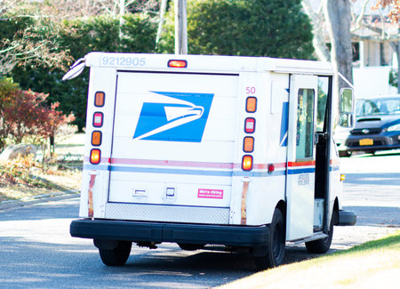 Babylon, New York, USA - 12 December 2021: A united States Postal Delivery truck is parked on a...