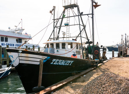 Narragansett, Rhode Island, USA - 27 June 2021: A commercial fishing vessel is tied up to a dock in...
