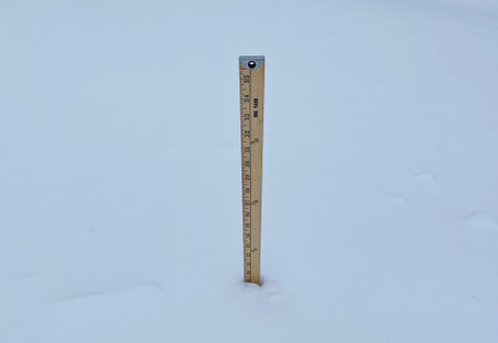 Yard stick in nineteen inches of snow demenstrating how much snow is on the ground after a snow storm.の写真素材