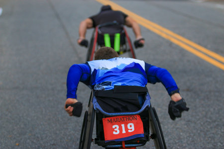 Wheelchair athletes racing in a marathon on the roads in Suffolk County Long Island New York.の写真素材