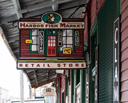 Portland, Maine, USA - 20 July 2019: A store sign hanging from the side of a building for the Harbor Fish Market.のeditorial素材