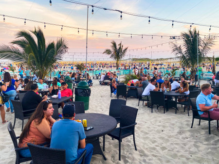 Babylon, New York, USA - 23 July 2022: A group of people sitting at tables on the sand at Cedar Beach on Long Island New York.のeditorial素材