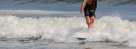 One man having fun walking on his surfboard while riding on a wave.
