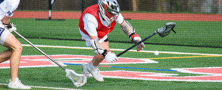 Exciting action as two lacrosse players strive for control of the ball during practice.の写真素材