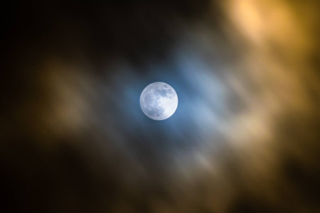 Full super-moon with clouds moving pastの写真素材