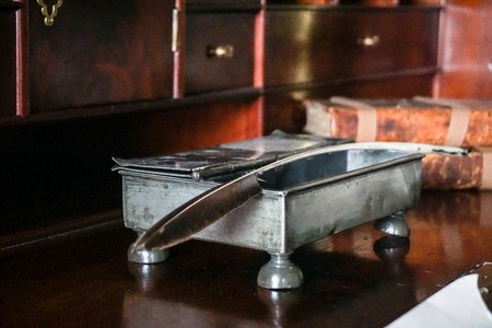 Vintage ink feather and accessories on vintage desk in lowlightの写真素材