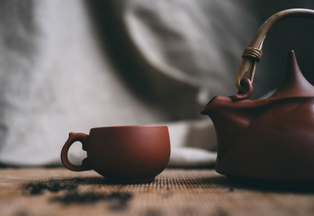 Chinese Tea Ceremony. Brown tea cup and tea pot on bamboo matの写真素材