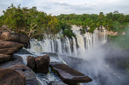 Kalandula waterfalls of Angola in full flow with lush green rain forest, rocks and sprayの写真素材