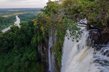 Kalandula waterfalls of Angola in full flow with lush green rain forest and the river in the distanceの写真素材