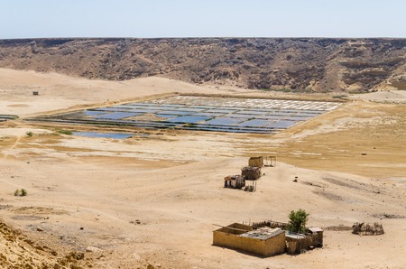 Traditional sea salt farming in square pools at Angola's Namib Desert coast line.の写真素材