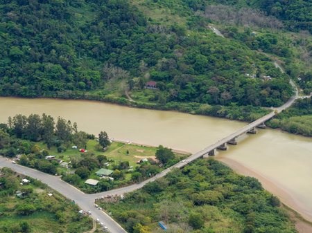 Aerial view of bridge crossing brown river at South Africa's Wild Coast near Port St. Johns.の写真素材