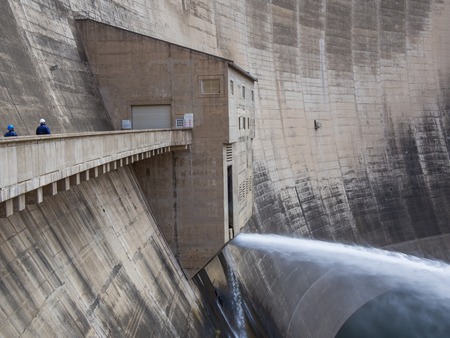 Release of water and two workers at impressive Katse Dam hydroelectric power plant in Lesotho, Africaの写真素材