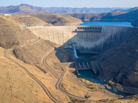 Impressive Katse Dam hydroelectric power plant and service roads in Lesotho, Africaの写真素材