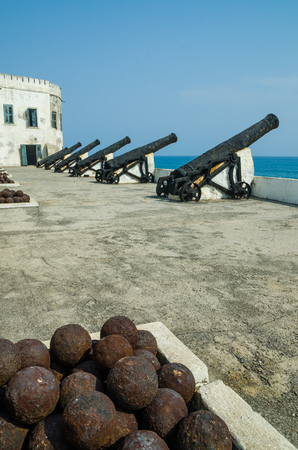 Famous slave trading fort of colonial times Cape Coast Castle with old cannons and white washed walls, Ghana, Africaの写真素材
