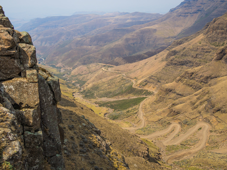 The famous Sani mountain pass dirt road with many tight curves connecting Lesotho and South Africaの写真素材
