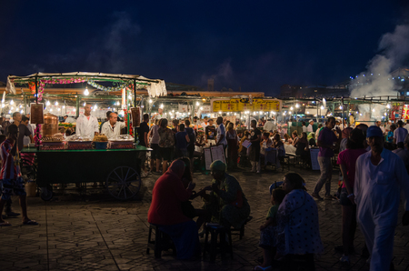 Marrakesh, Morocco - September 05 2013: Food stands with smoke and light on famous Jamaa el Fna square in eveningのeditorial素材