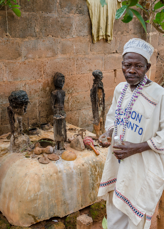 Abomey, Benin - March 07, 2014: African voodoo fetish priest performing ritual at outdoor vodoo shrineのeditorial素材